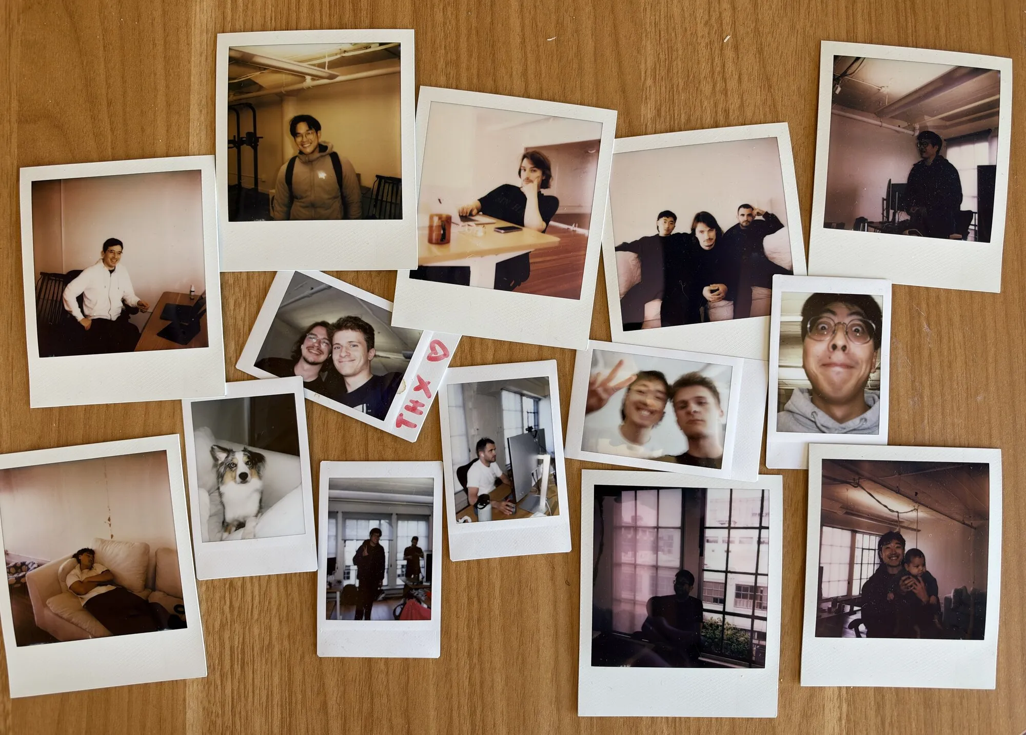Instant photos of the Charcoal team at work and at the office, spread across a wooden table.